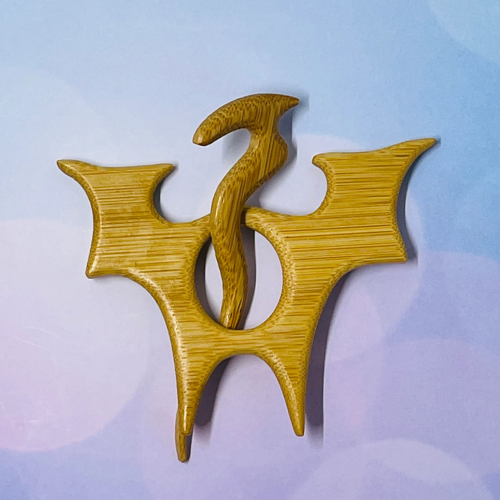 Wooden brooch with a unique design on a light blue background