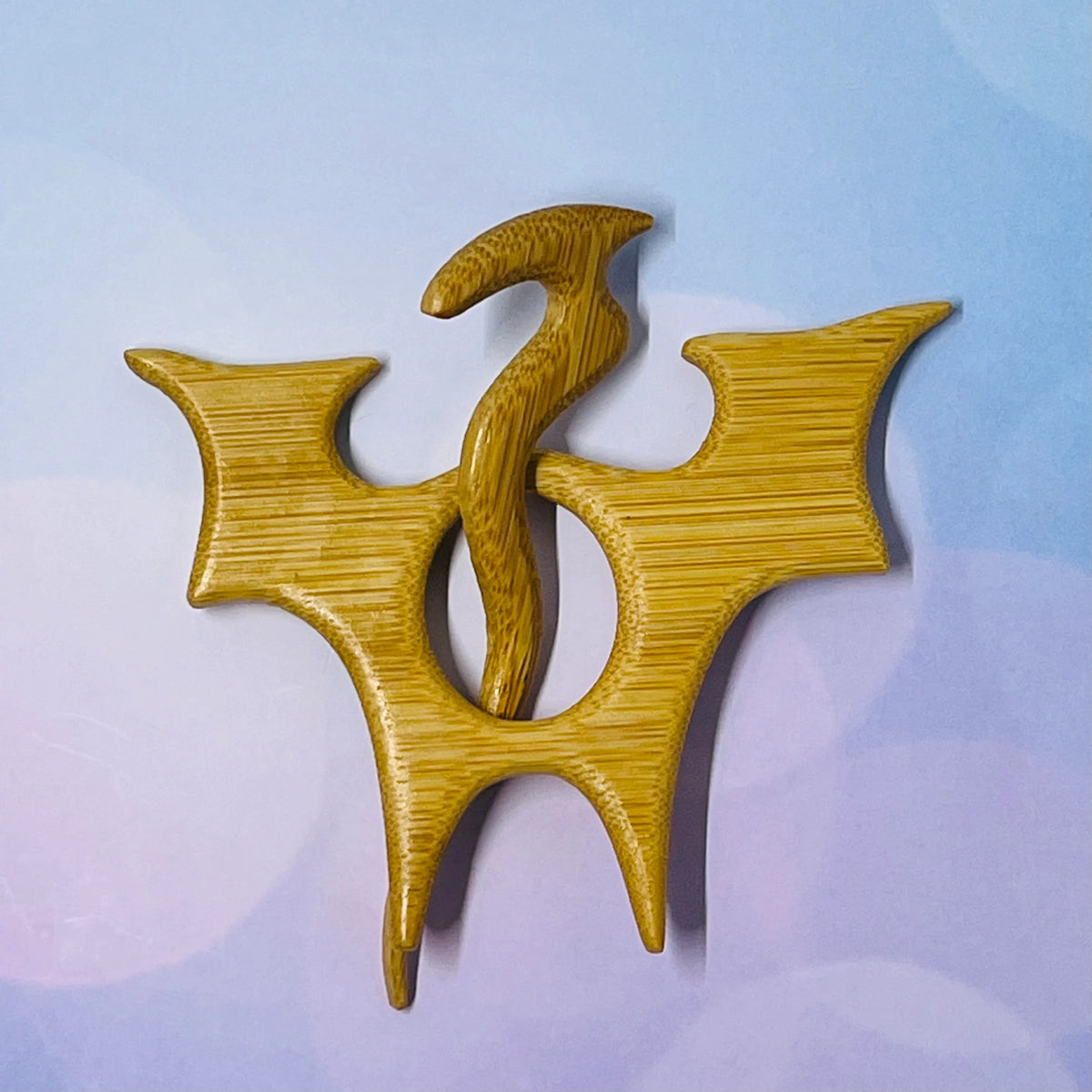 Wooden brooch with a unique design on a light blue background