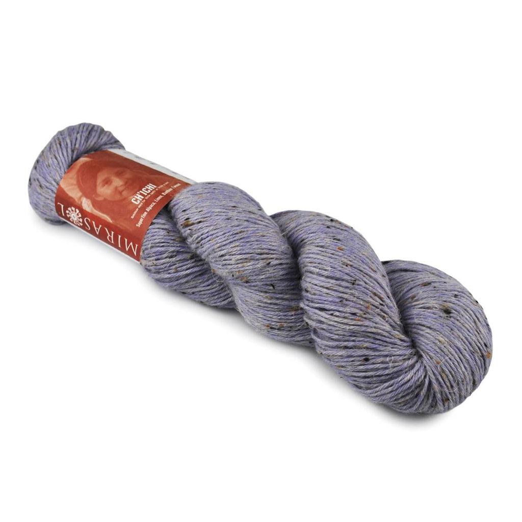 Blue skein of yarn with a label on a white background
