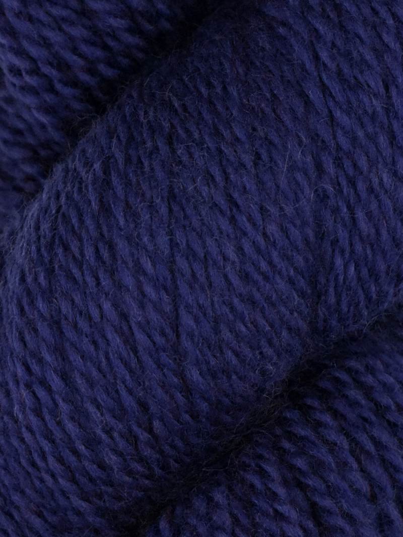 A close-up of dark navy blue yarn showing its soft, twisted texture.