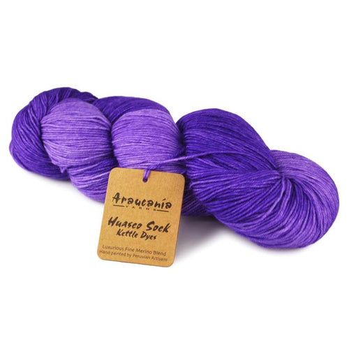Purple skein of yarn with a brand tag on a white background