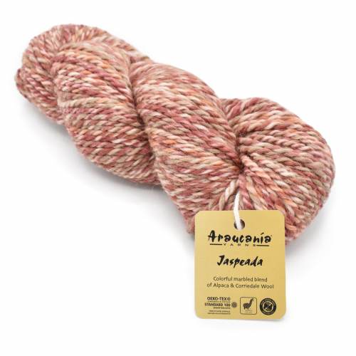 A skein of Arouseton Jaspéda yarn in a marled blend of dusty pink, beige, and muted red tones, with a yellow paper label attached, on a plain white background.