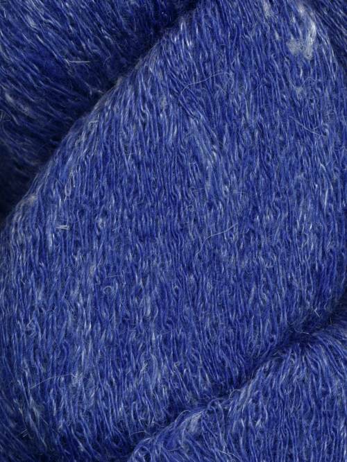 A close-up of textured yarn in a rich medium-to-deep blue color with subtle lighter blue and white flecks throughout.
