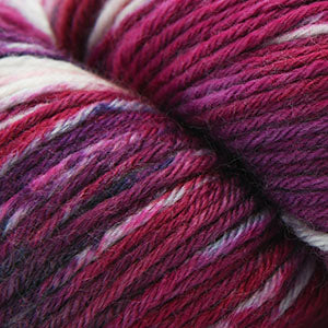 Close-up of multicolored yarn with a focus on pink and purple shades.