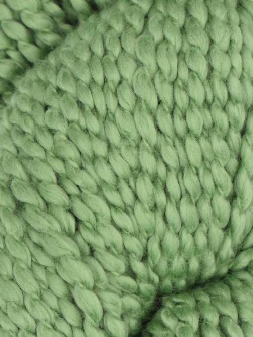 Close-up of green knitted yarn ball