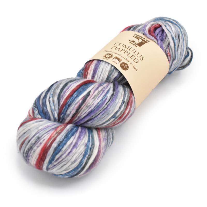 A skein of variegated yarn with blue, purple, red, and white stripes, wrapped in a beige paper label that reads 'CUMULUS DAPHNEUS'.