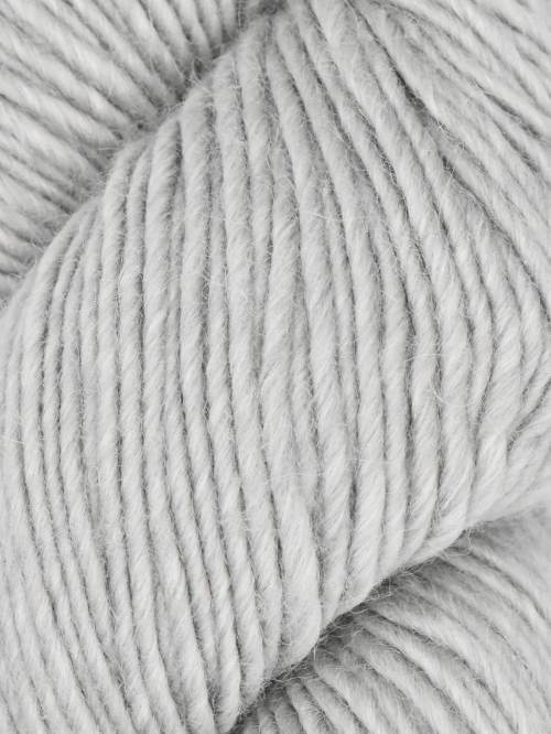 A close-up of light gray plied yarn, showing the texture and color of the twisted fibers.