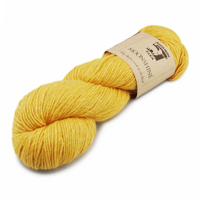 Yellow skein of yarn with a label on a white background
