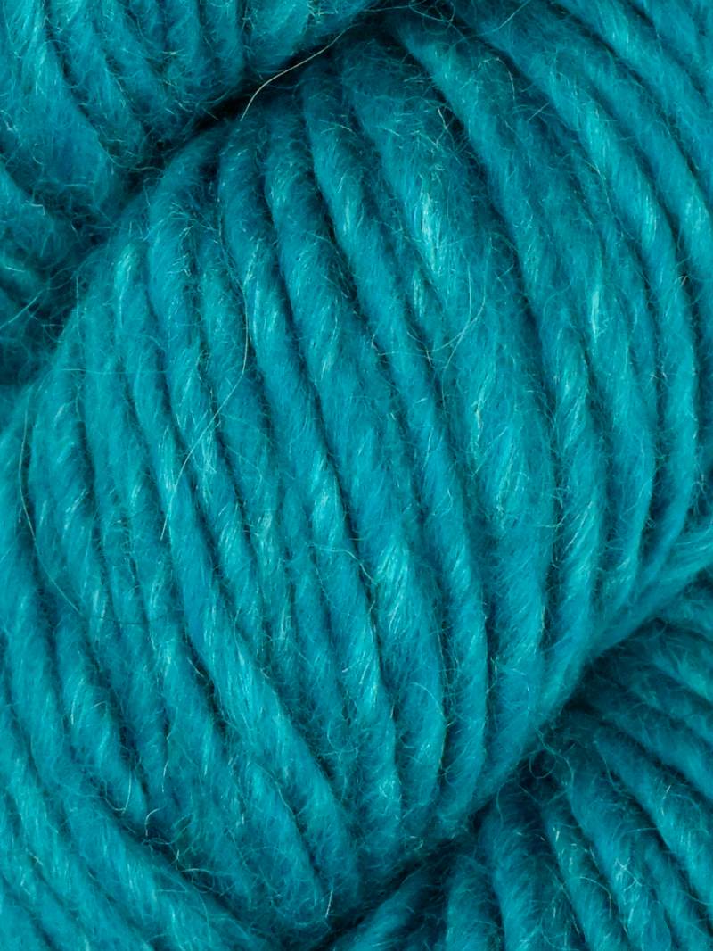Close-up of teal yarn with a soft texture