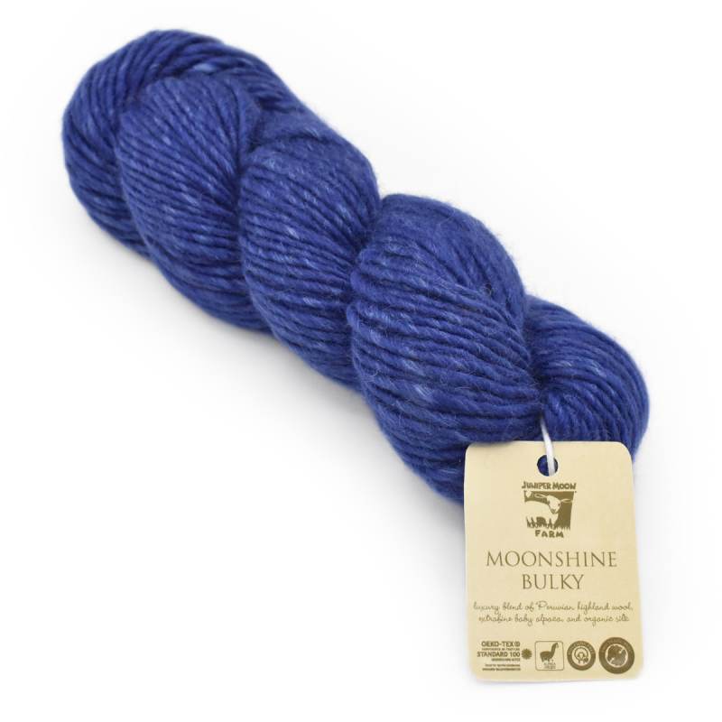 Blue yarn skein with a label on a white background