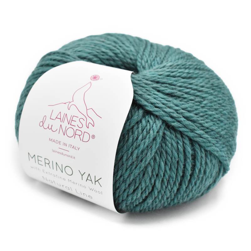 Teal skein of yarn with a label on a white background