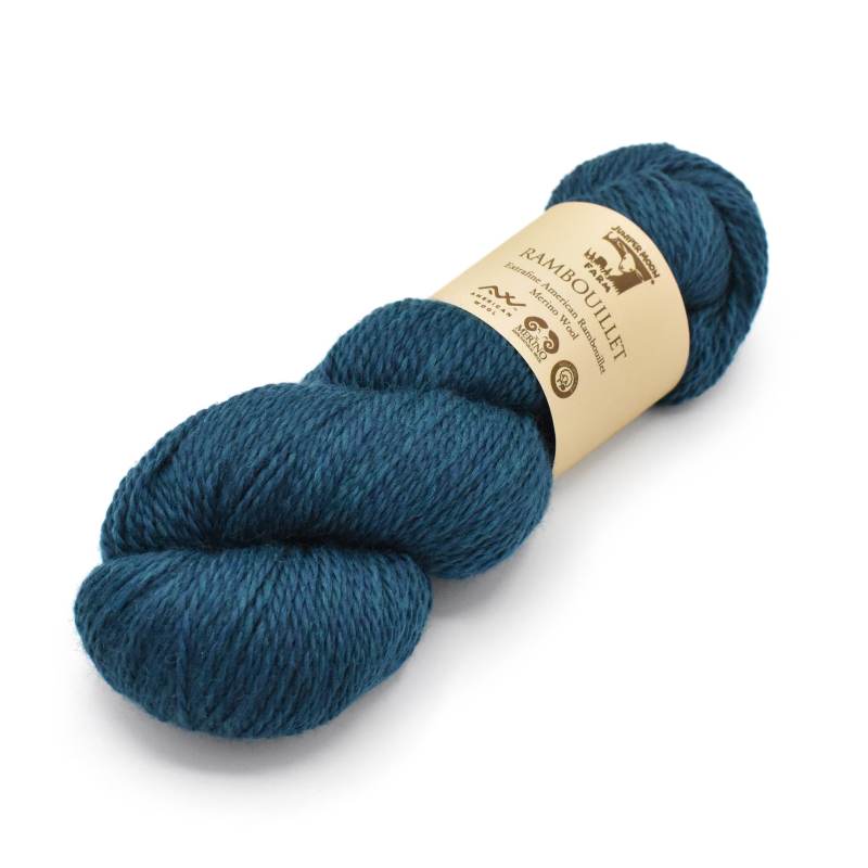 Blue skein of yarn with a label on a white background