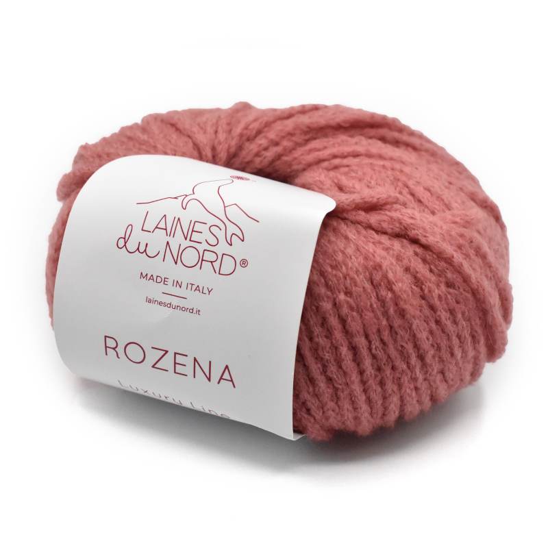 A skein of dusty rose pink yarn with a white paper label reading 'Laines du Nord' and 'ROZENA', photographed on a clean white background.