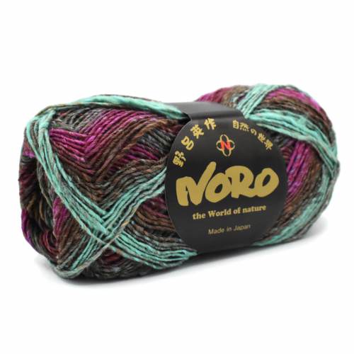 A skein of NORO yarn with variegated colors of teal, purple, brown, and black, wrapped with a black label featuring gold lettering.
