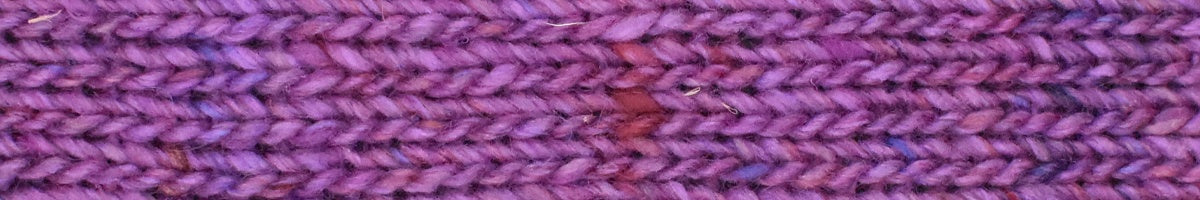 Close-up of a textured purple fabric with a subtle pattern