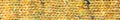 A close-up texture shot of a chunky knit fabric in a variegated blend of mustard yellow, beige, orange, and soft pink yarn.