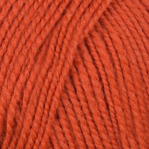 A close-up of twisted yarn strands in a warm rust orange color, filling the entire frame.