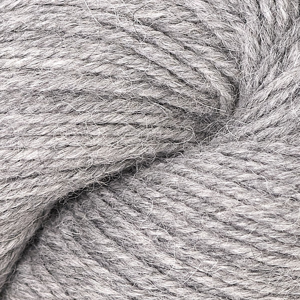 A close-up of light gray twisted yarn with a soft, fuzzy texture filling the frame.