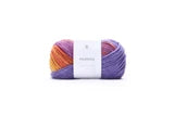 A single ball of variegated yarn with a white paper label, shown against a plain white background.