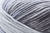 Close-up of a ball of light gray yarn with soft, fuzzy texture.