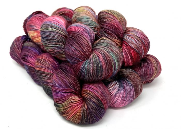 Multicolored skeins of yarn on a white background