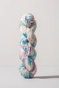 Multicolored skein of yarn on a light gray background