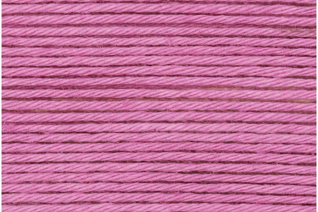 A close-up texture shot of bright pink embroidery thread wound horizontally.