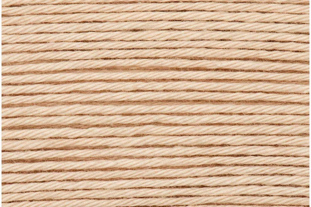A close-up texture shot of light tan twisted cotton cord or thread, filling the entire frame.