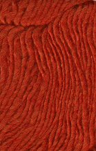 A close-up texture shot of a chunky, ribbed knit fabric in a warm rust-orange color.