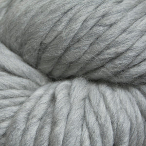 A close-up of light gray yarn with a soft, fuzzy texture filling the frame.