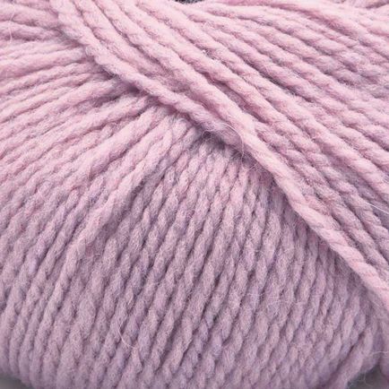 A close-up of dusty pink yarn wound into a skein, showing the soft, twisted texture of the fibers.