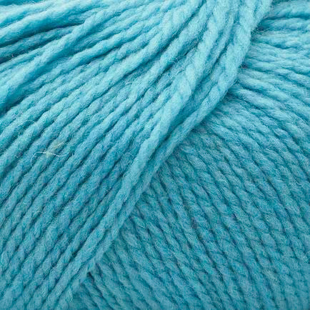 A close-up of dusty light blue yarn strands, showing the soft texture and twisted ply structure of the fiber.
