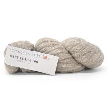 A skein of light oatmeal-colored yarn with a white paper label that reads 'PLYMOUTH PURE BABY LEAVEN 100' on a clean white background.