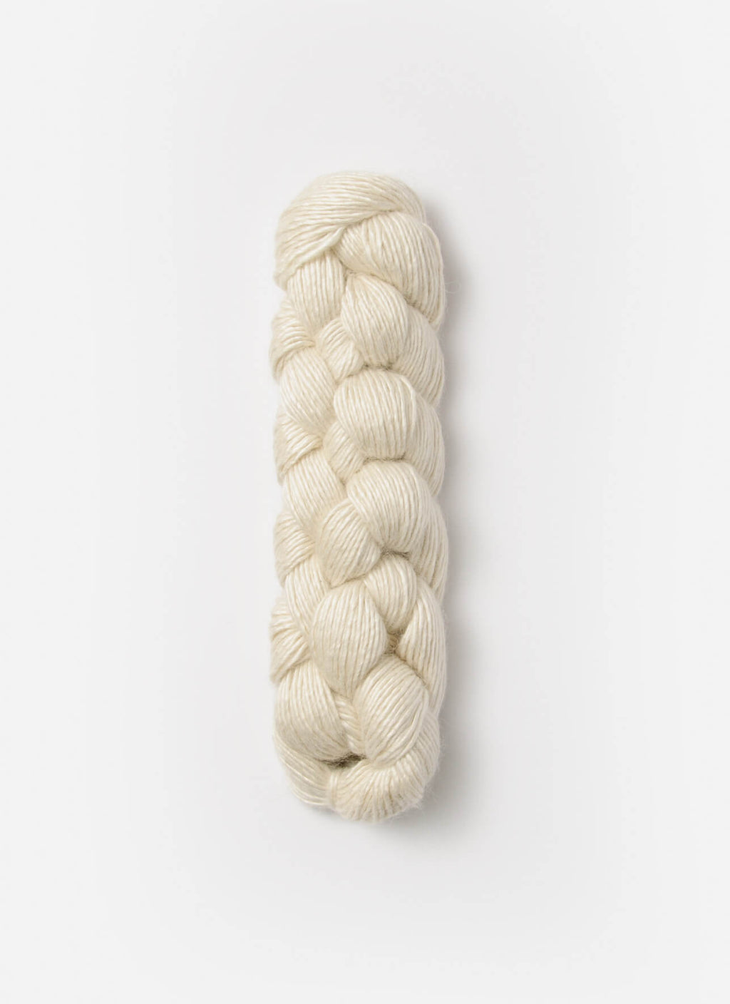 Braided skein of cream-colored yarn on a white background