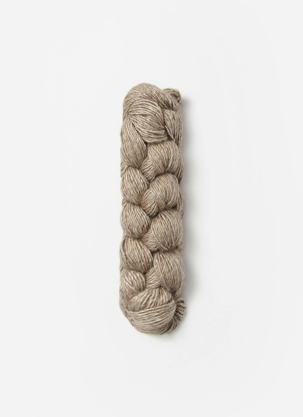 A single braided skein of heathered taupe yarn, photographed vertically against a clean, light off-white background.