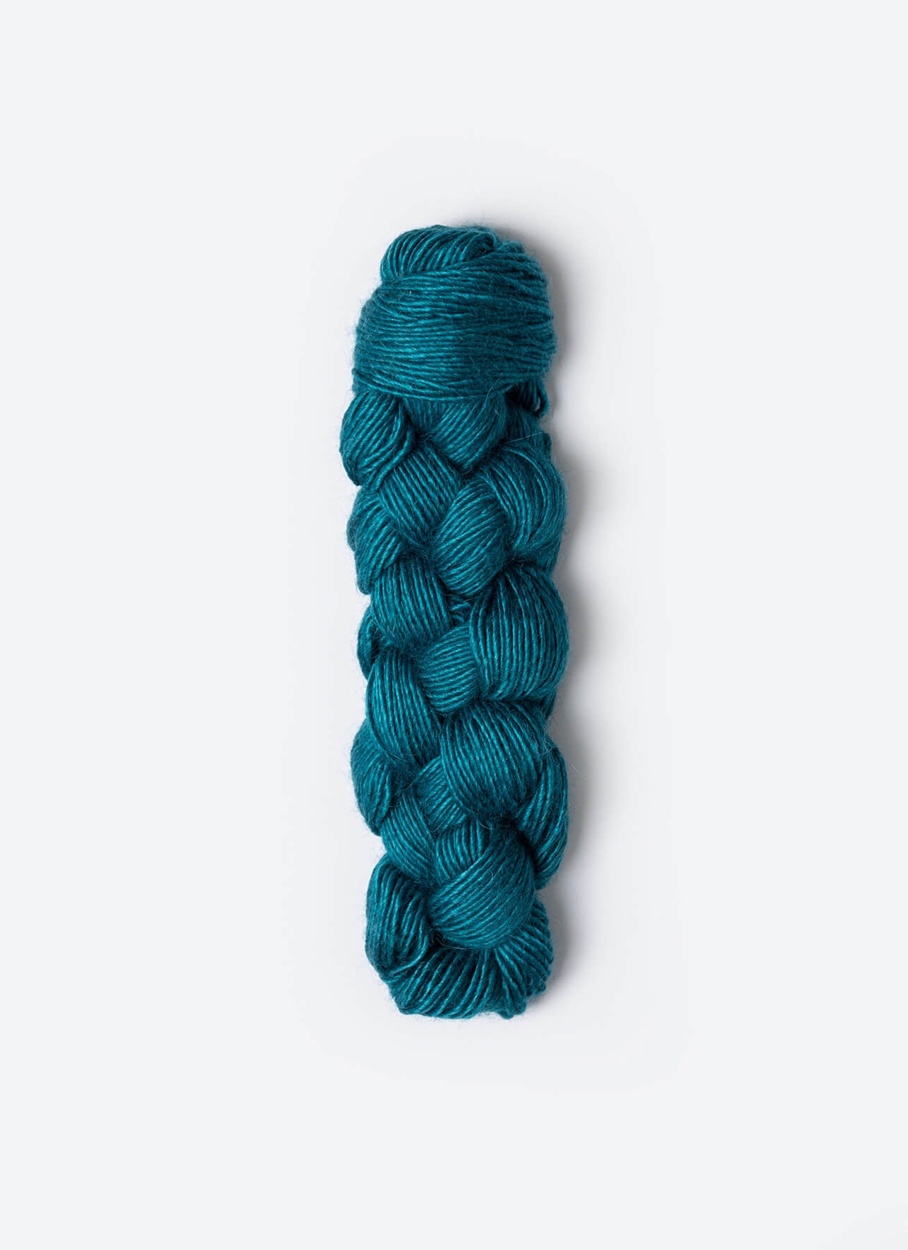 Braided teal yarn on a white background