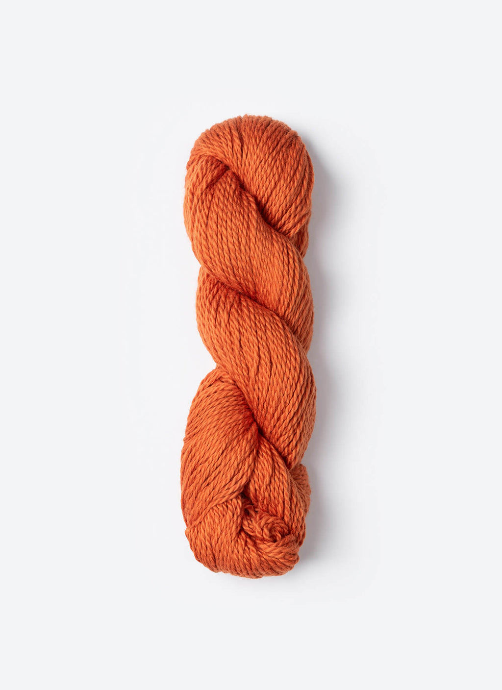 Braided orange yarn on a white background