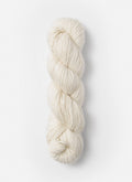 A single skein of cream-colored yarn standing vertically against a clean, light off-white background.
