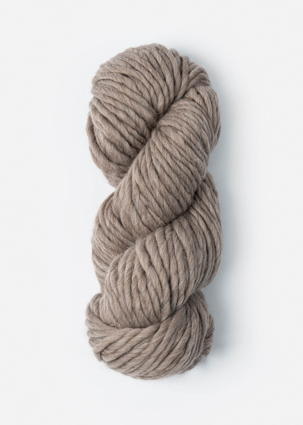 Coiled skein of beige yarn on a white background