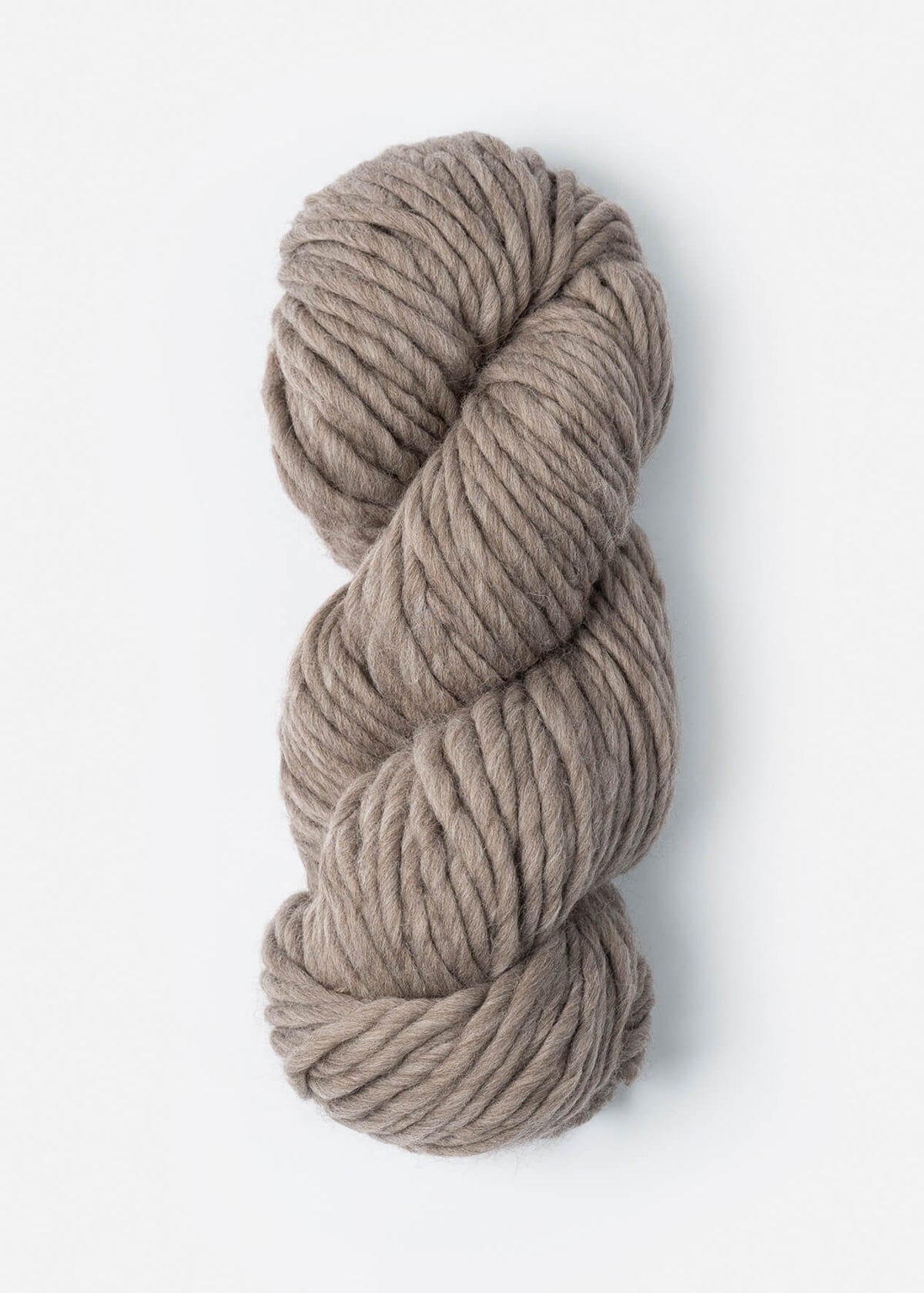 Coiled skein of beige yarn on a white background