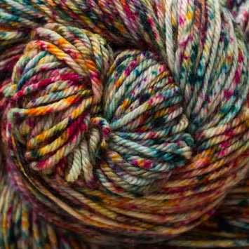 Close-up of a skein of variegated yarn with mixed pastel and bright threads in pink, blue, yellow, orange, and cream.
