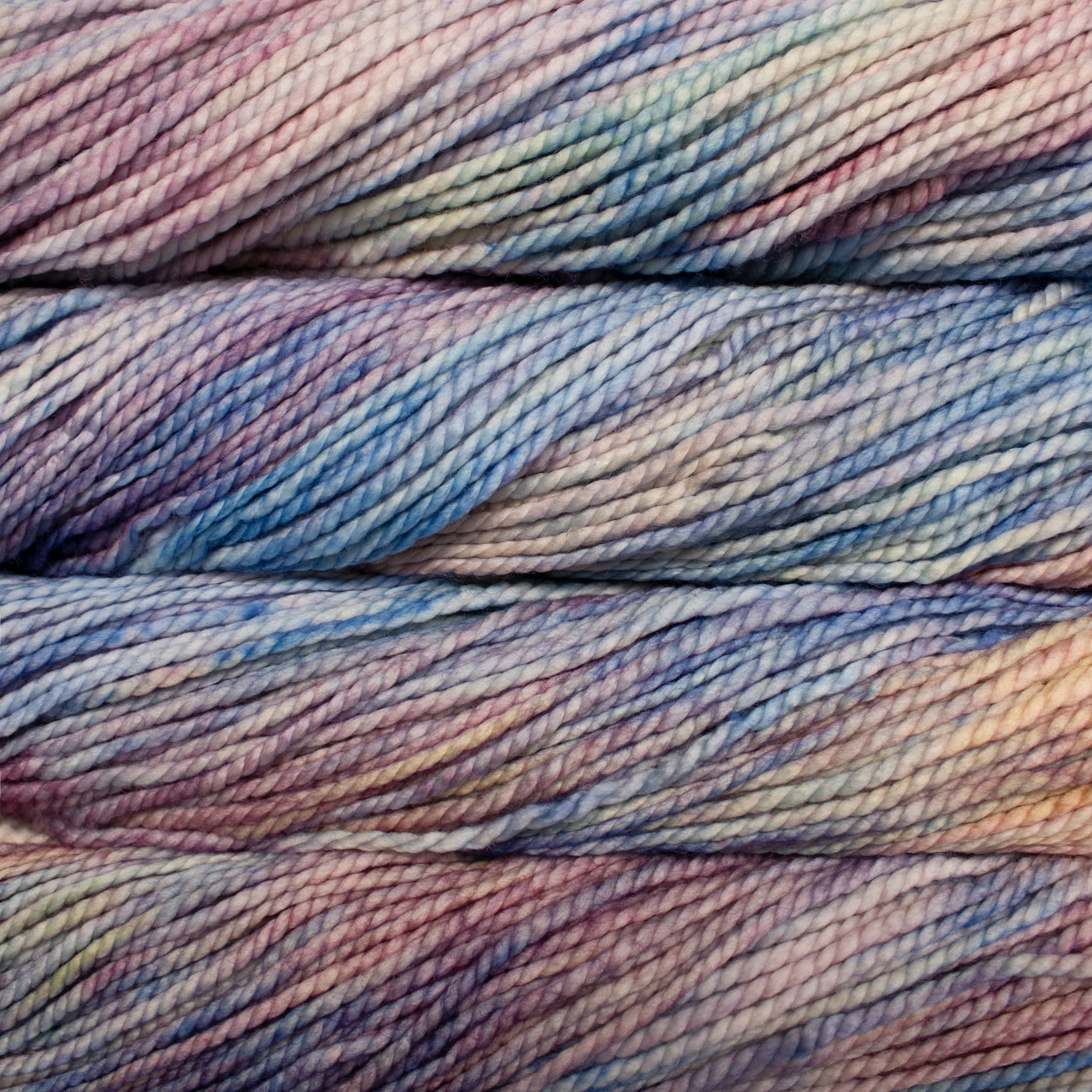 Close-up of multicolored yarn with shades of blue, purple, and pink.