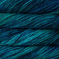 Close-up of variegated yarn strands in deep teal, blue, and green tones.