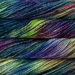 Close-up of variegated yarn skeins showing a multicolor blend of deep blue, purple, green, and yellow tones.
