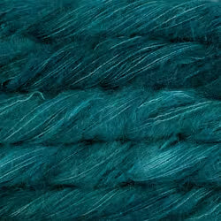 A close-up of dark teal yarn wound into skeins, showing its soft, fuzzy texture and subtle sheen.