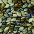 A close-up of a textured knit fabric featuring a multicolor pattern of olive green, yellow, blue, and brown leaf-like or scalloped shapes.