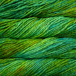 Close-up of variegated yarn in shades of green and yellow, showing the twisted plies and soft texture.