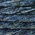 A close-up texture of dark, layered stone or wood grain with horizontal striations in charcoal gray, black, and subtle blue-green undertones.