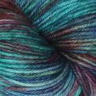 A close-up of a skein of variegated yarn with blended teal, green, blue, and purple fibers.