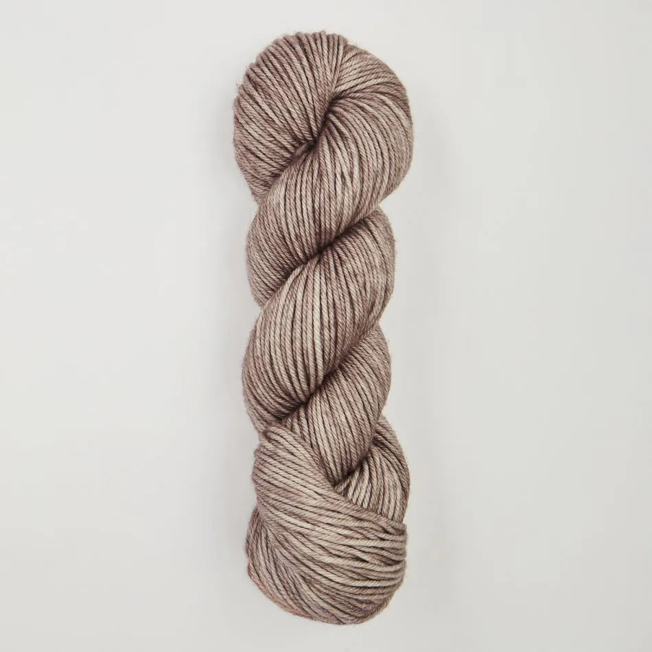 Single skein of brown yarn on a light gray background